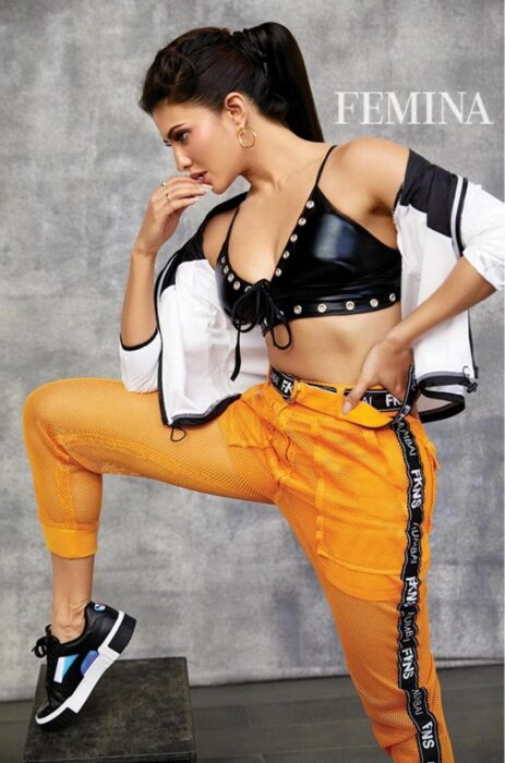 Jacqueline Fernandez Always Slaying It With Her Looks 6 hooded half stripe patterned white jacket on a black leathery bralette top 1